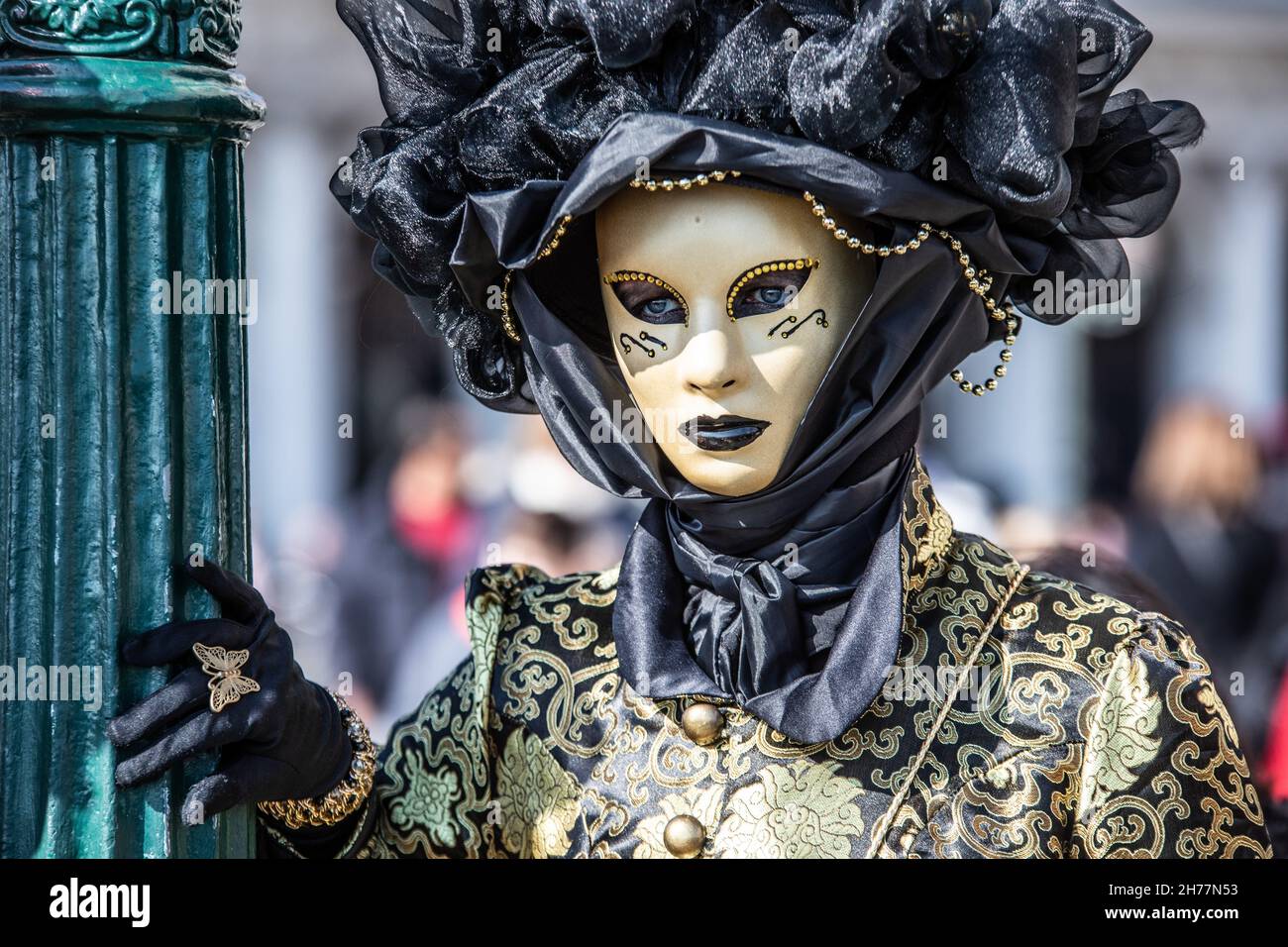 A person wearing a carnival mask and costume in Venice, Italy