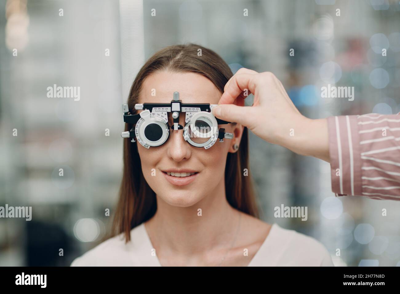 Portrait of young woman during eye examination test glasses goggles at