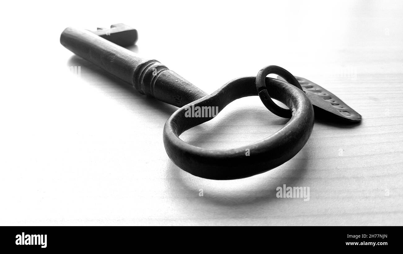 An old key on a white background Stock Photo - Alamy