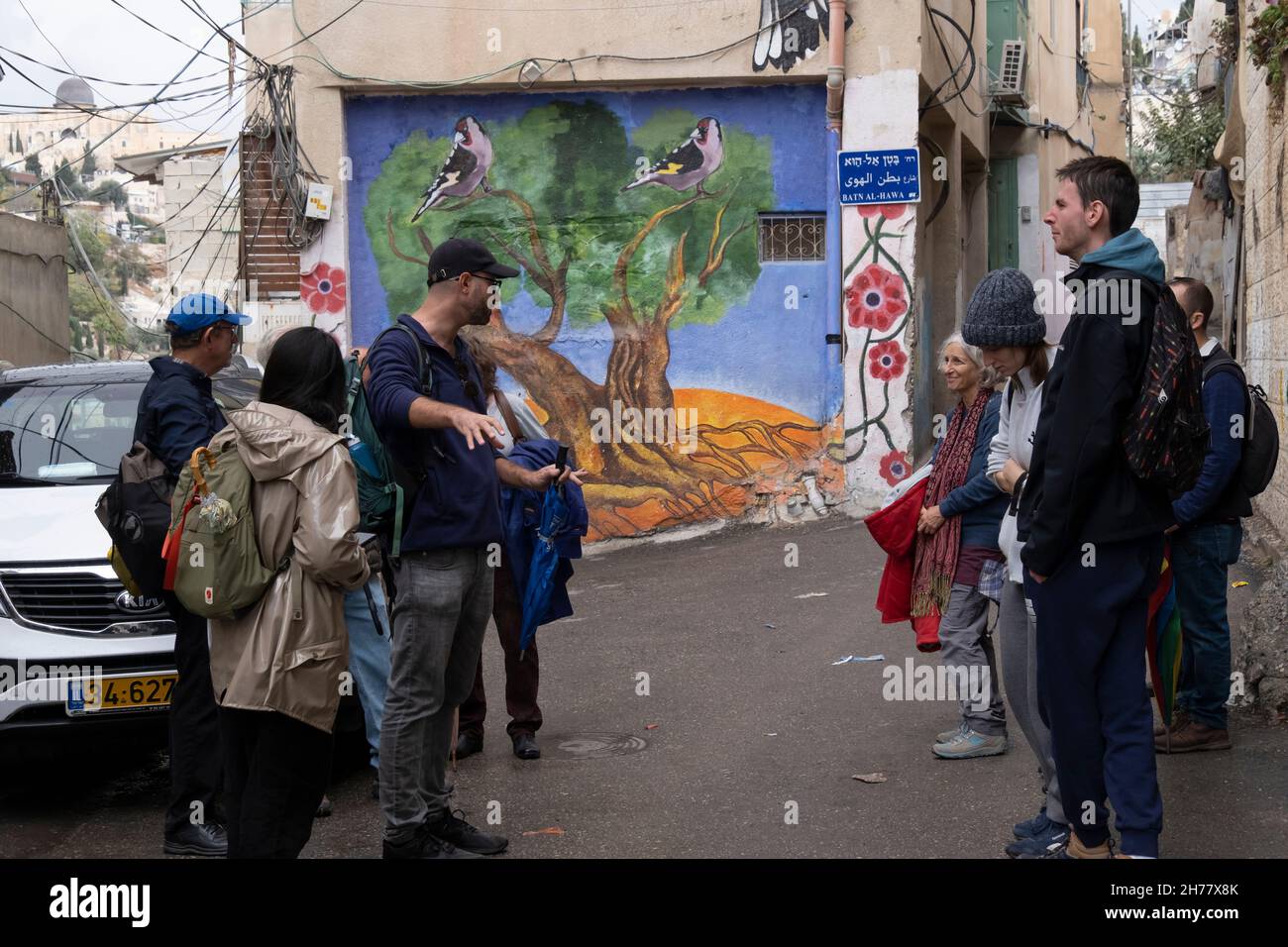 A group of Israelis and tourists take part in a study tour conducted by Ir Amim nonprofit