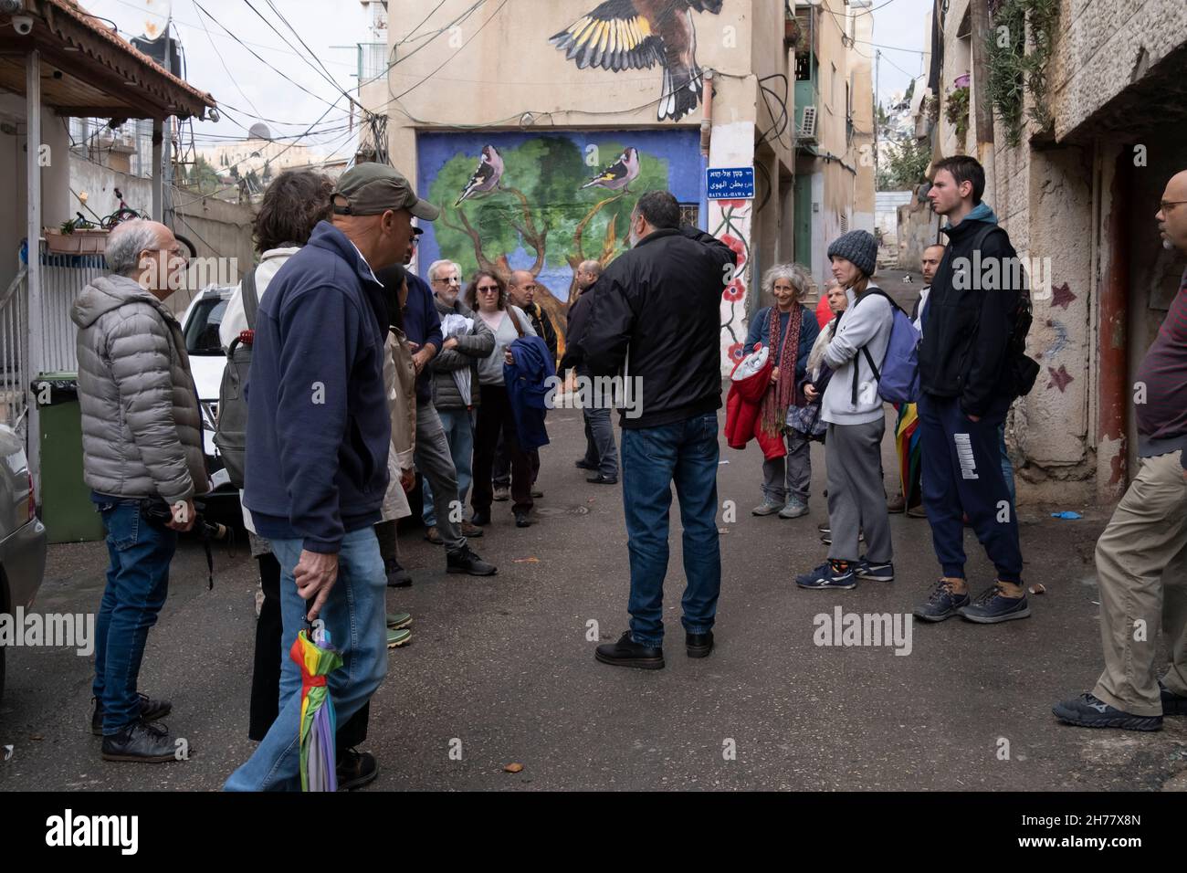 A group of Israelis and tourists take part in a study tour conducted by Ir Amim nonprofit