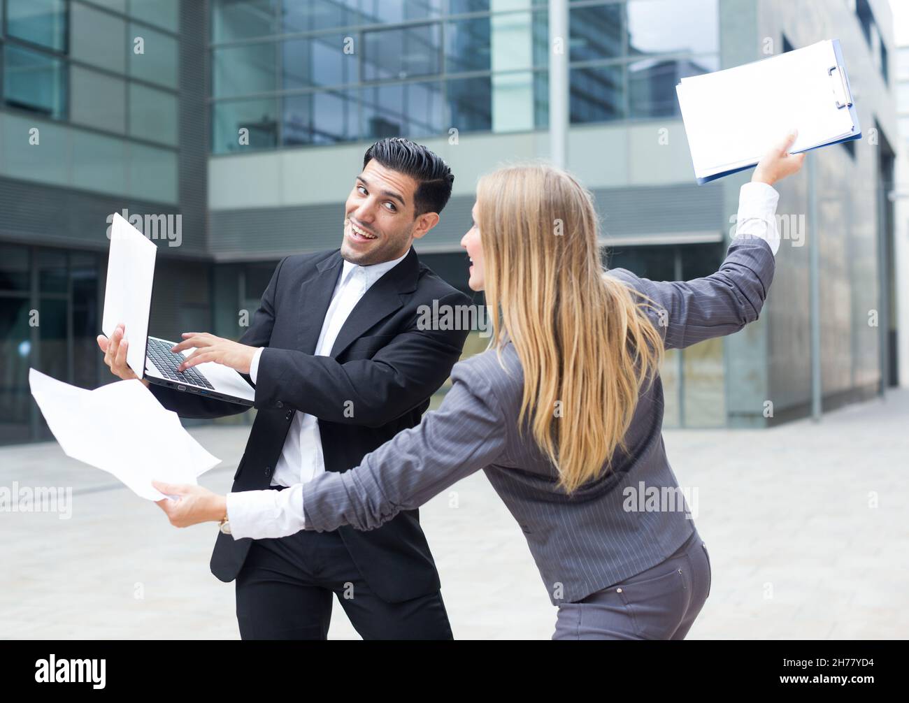 Couple professionals are having fun with laptop in time break Stock ...