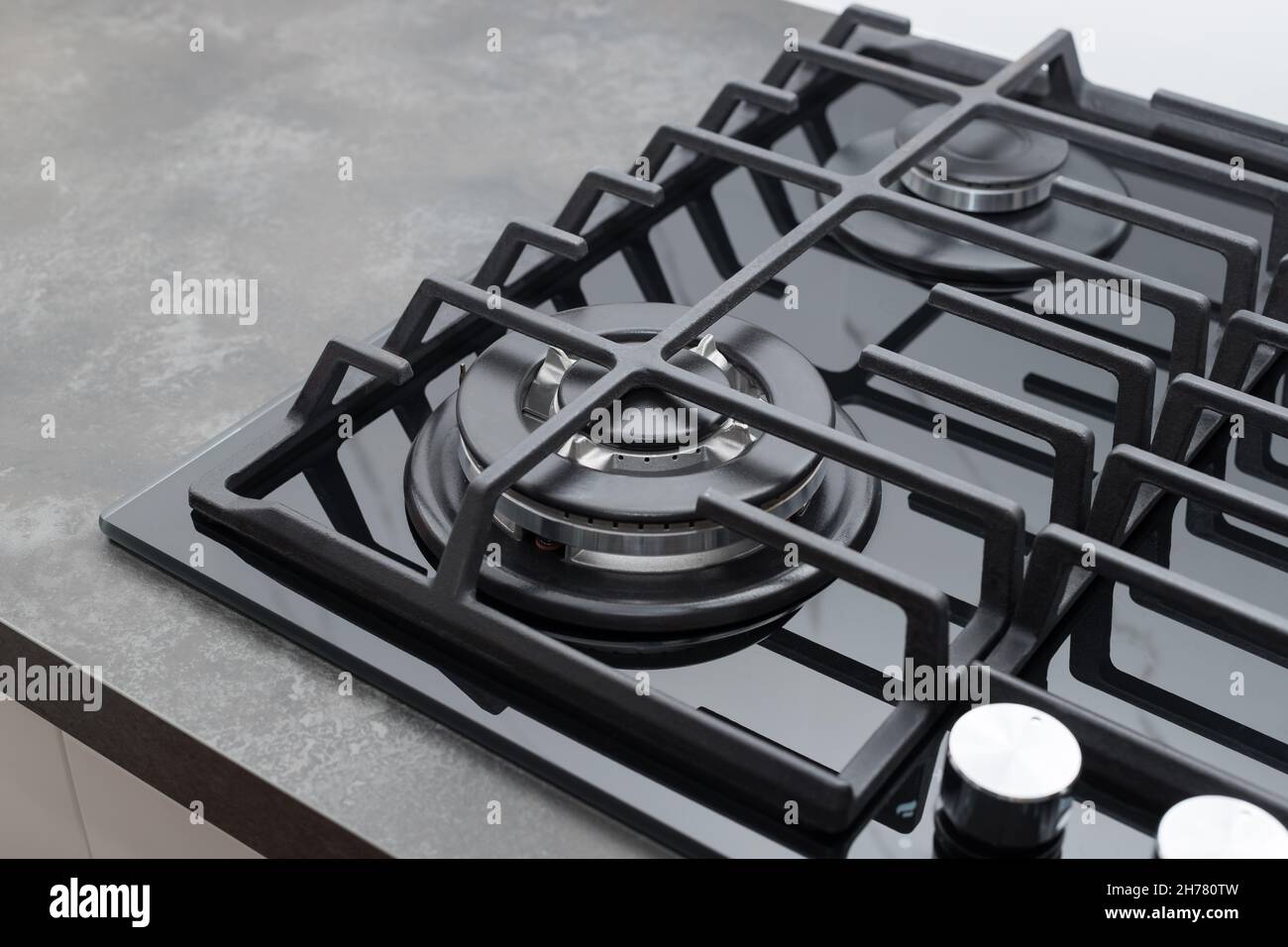 Black glass gas stove top on dark countertop at home Stock Photo Alamy