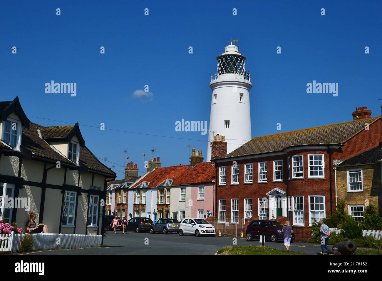Southwold Lighthouse behind houses in a residential street in Southwold