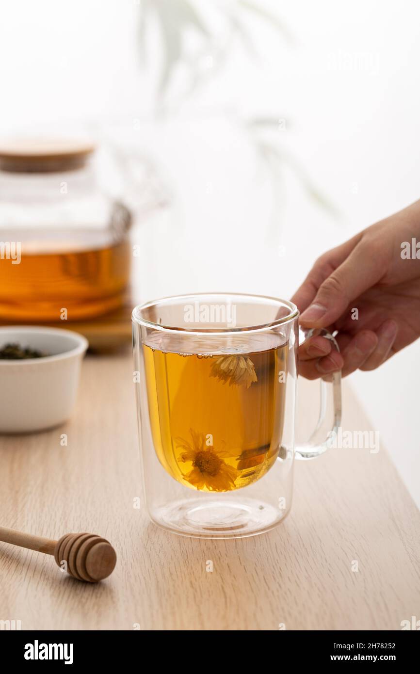 Hand Over Tea A vertical shot of a hand holding healthy, herbal tea Stock Photo - Alamy