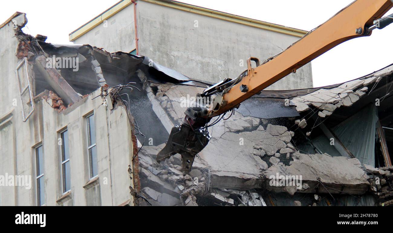 Long Arm of a Demolition Machine Grabbing Concrete. Stock Photo