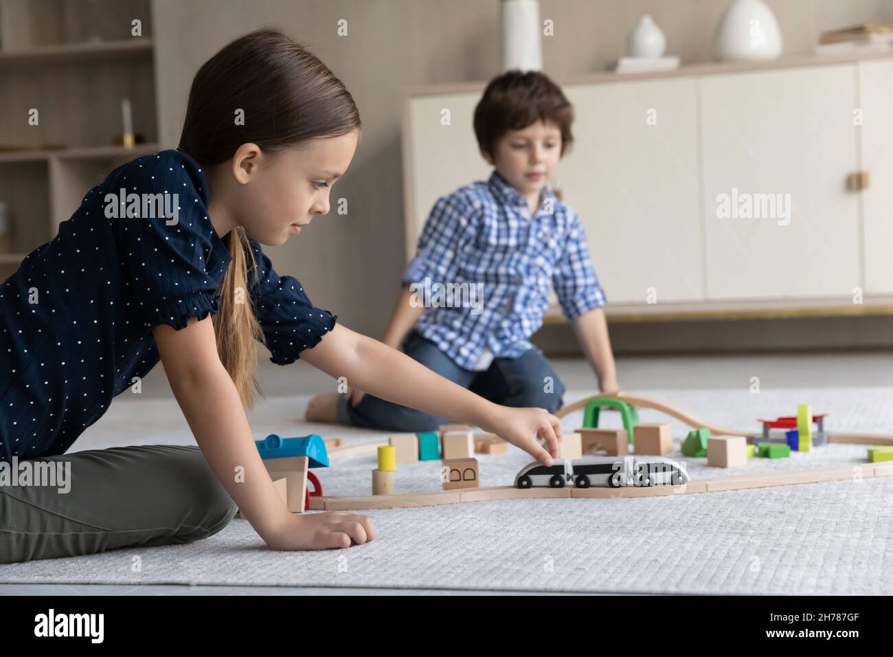 Brother and sister play railroad at home Stock Photo