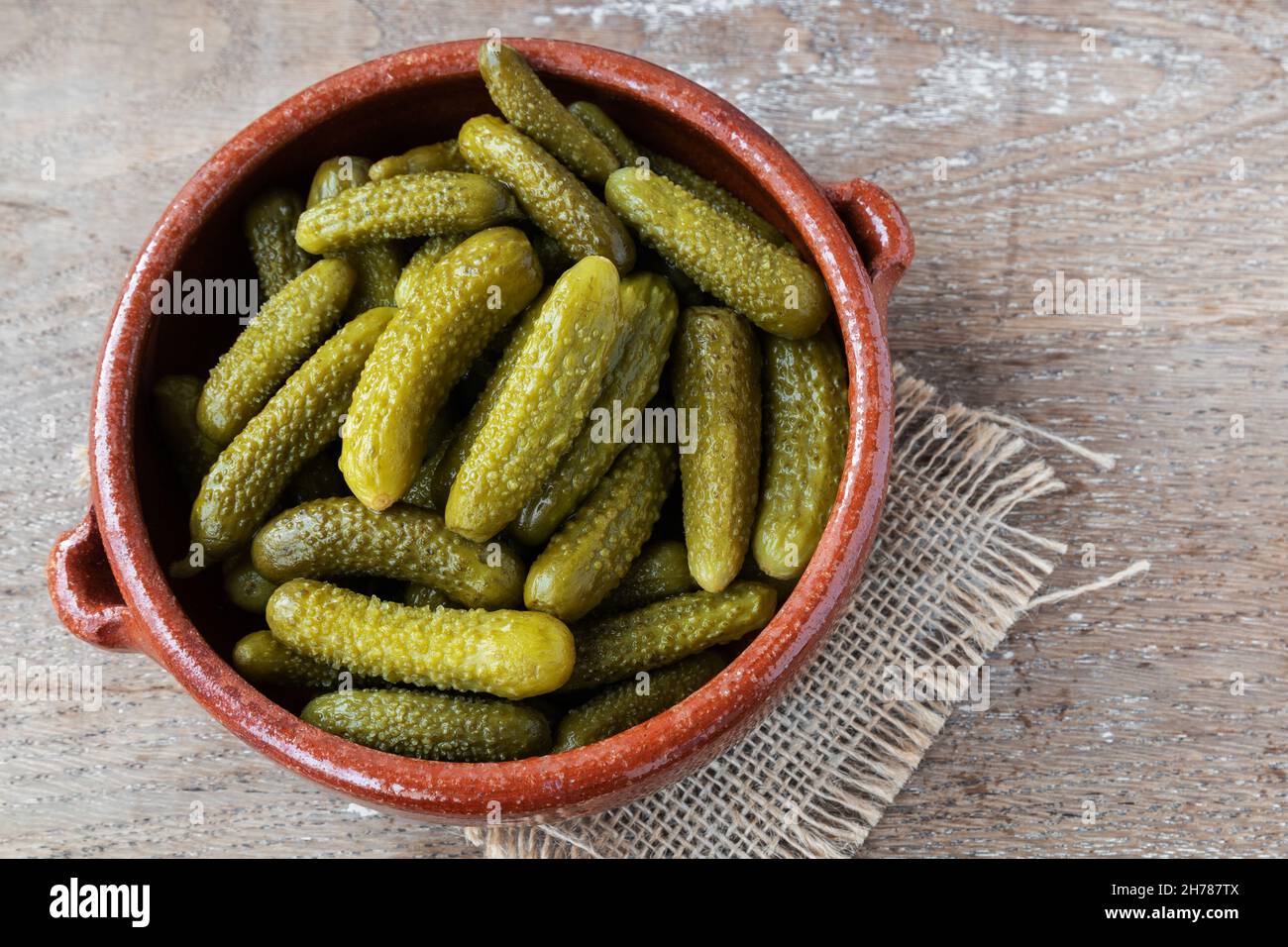 Pickled gherkins on rustic background Stock Photo