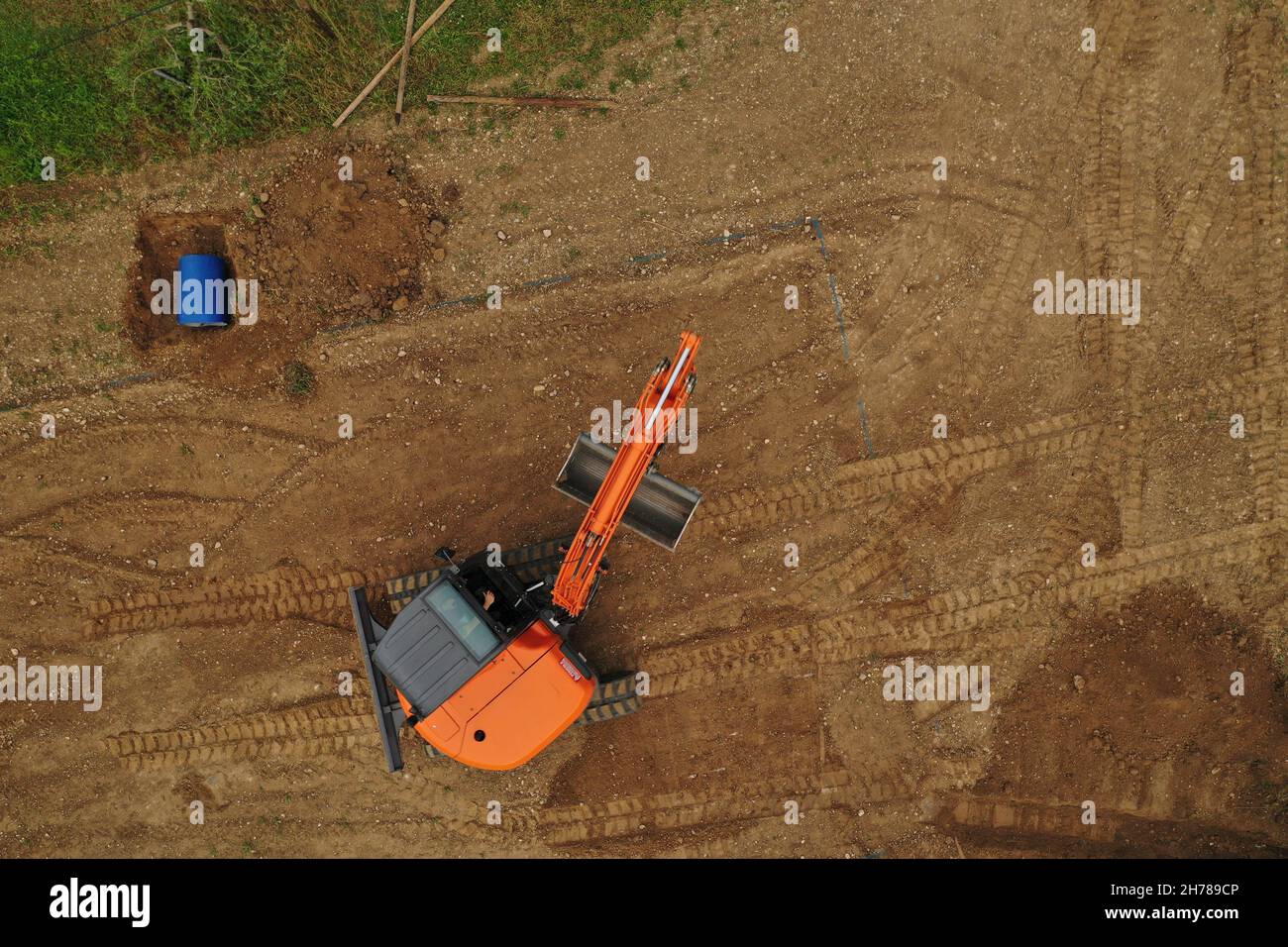 Aerial View orange Excavator Building volleyball court with sand Stock Photo