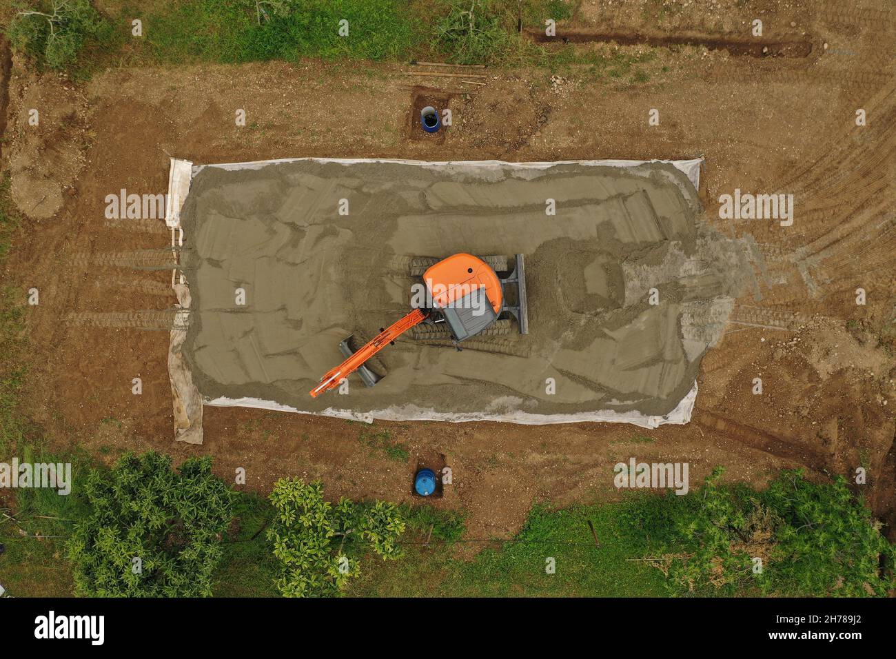 Aerial View orange Excavator Building volleyball court with sand Stock Photo