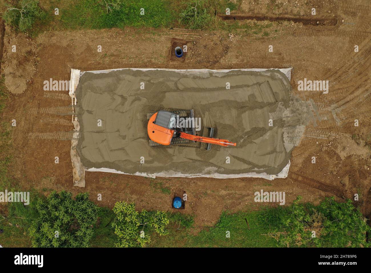 Aerial View orange Excavator Building volleyball court with sand Stock Photo