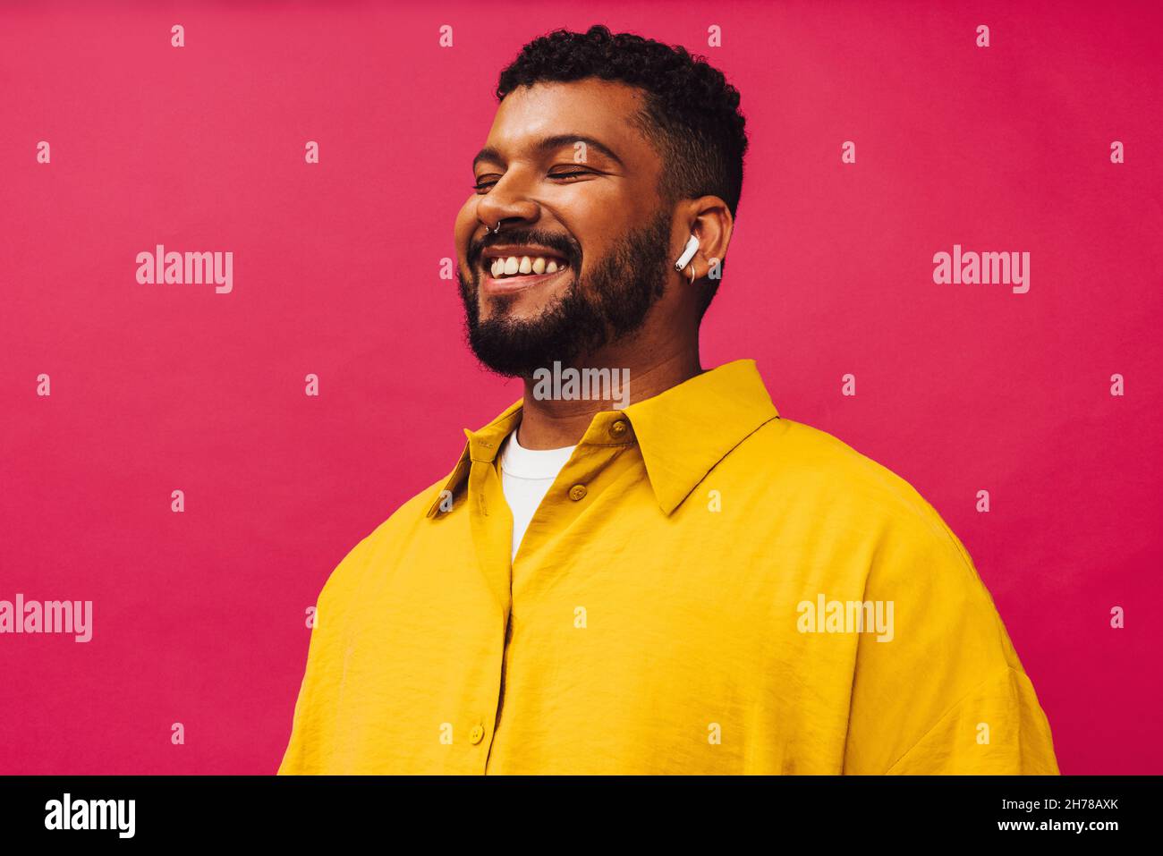 Man listening to his favourite podcast. Happy young man smiling ...