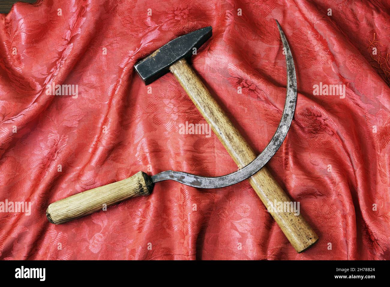 Sickle and hammer on rich red shawl Stock Photo