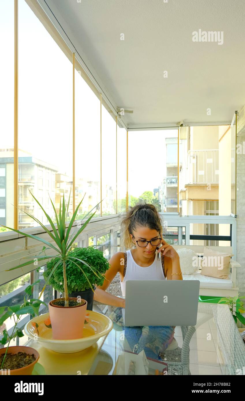 Young woman working from home on her laptop computer Stock Photo - Alamy