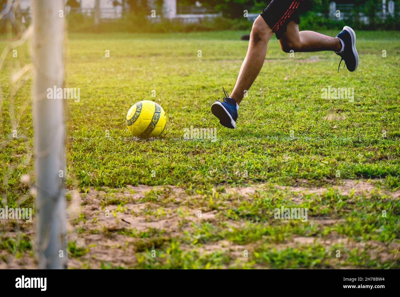 Football player training in soccer field. Young footballer practicing on football field Stock
