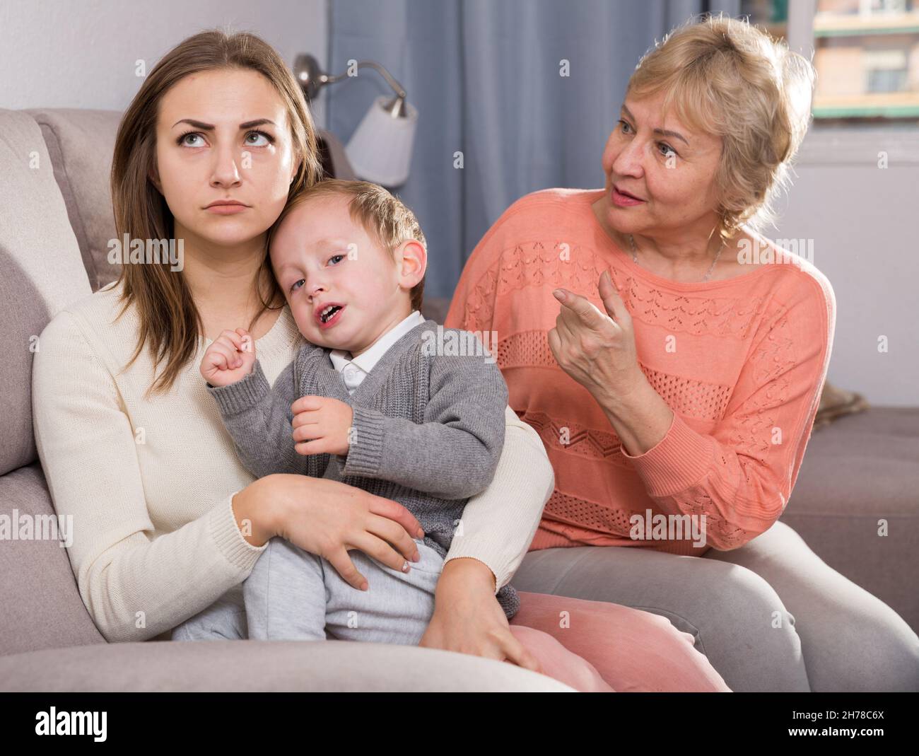 Two women are quarreling for upbringing toddler Stock Photo