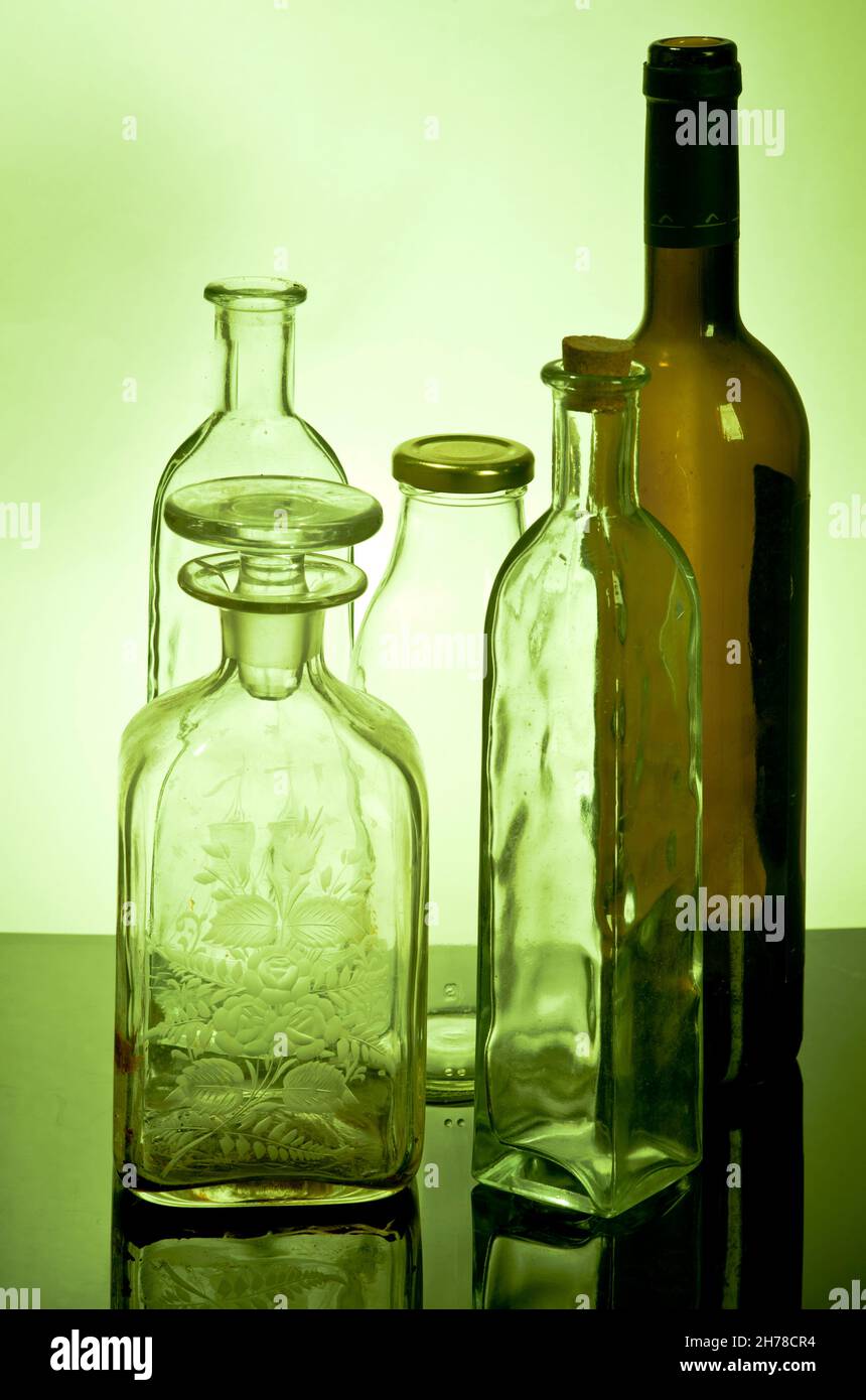 ,Still life of glass bottles in green light Stock Photo Alamy