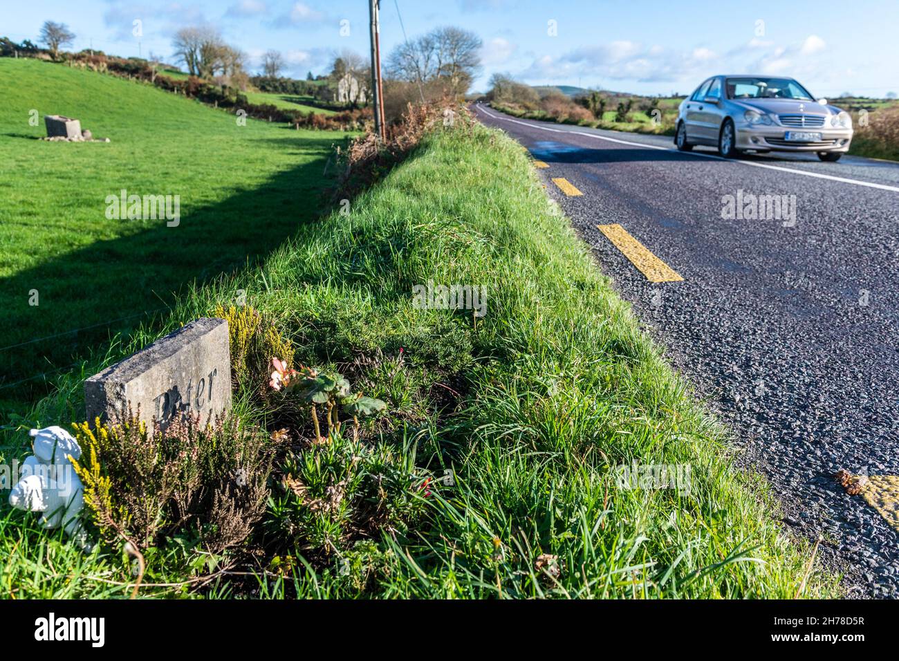 Drimoleague, West Cork, Ireland. 21st Nov, 2021. Cars drive past a roadside memorial bearing only the name 'Peter' on The World Day of Remembrance for Road Traffic Victims. This year 119 people have died and 868 people have been seriously injured on the roads in ireland. The Road Safety Authority CEO Sam Waide today pleaded for drivers to increase their road safety efforts. Credit: AG News/Alamy Live News Stock Photo