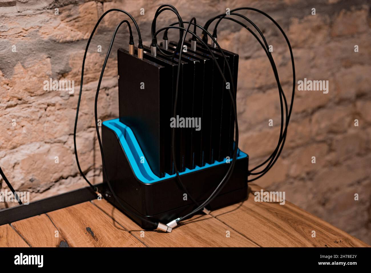 Many big portable phone chargers for charging phones stands inside a dock station on the table