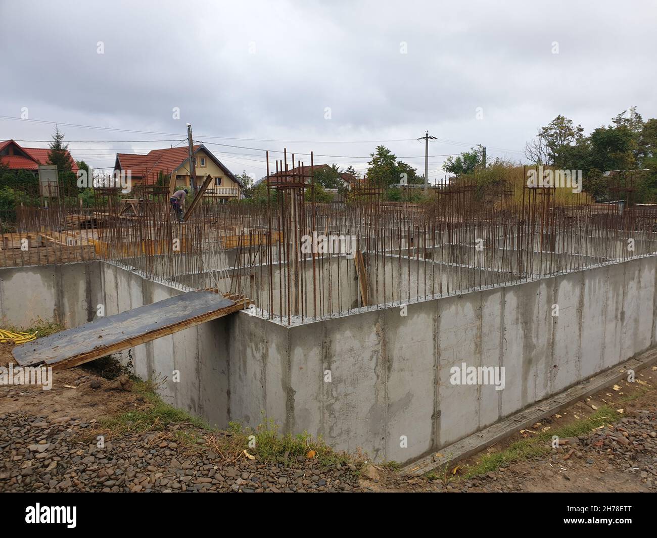 A view of unfinished concrete bases building with a hazy light blue sky ...