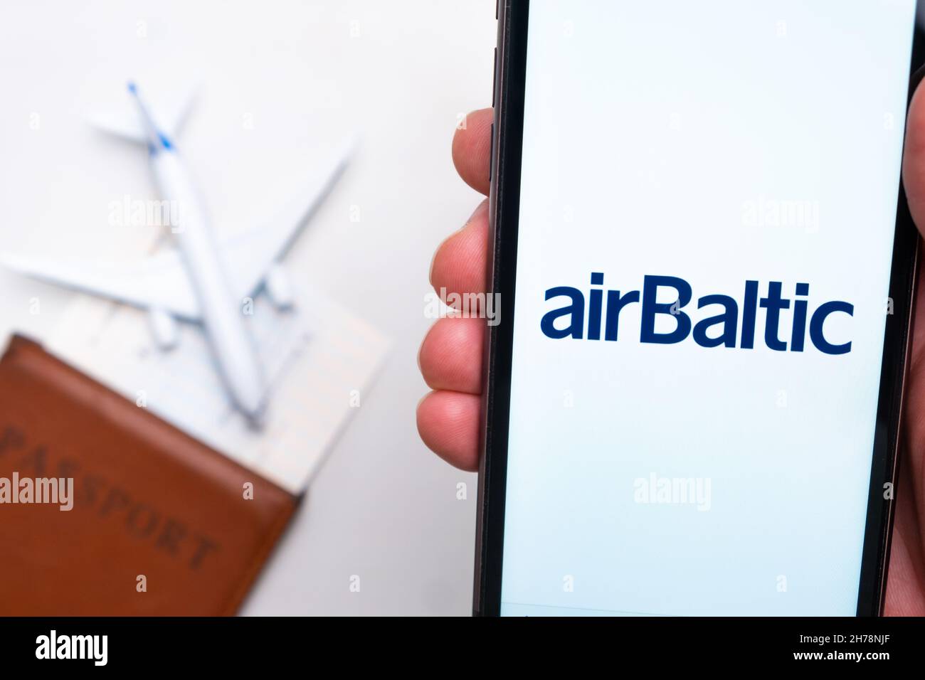 AirBaltic Airlines mobile app. A convenient mobile application for buying tickets using smartphone with a plane, passport and boarding pass on the background. November 2021, San Francisco, USA Stock Photo