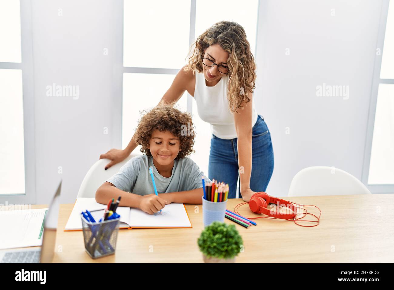 Mother and son smiling confident doing homework at office Stock Photo ...