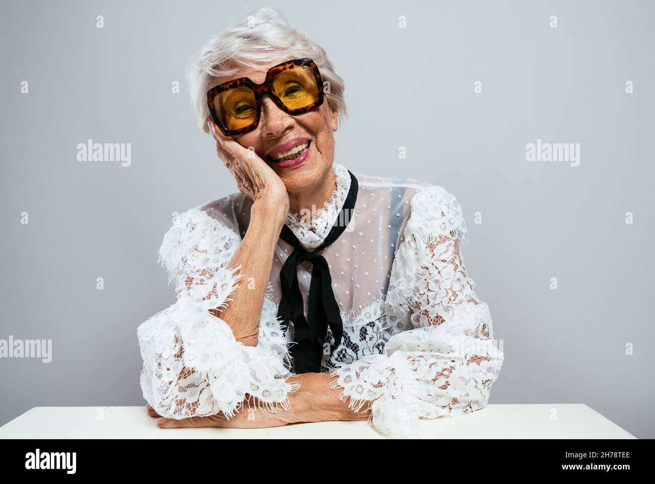 beautiful and elegant old influencer woman. Cool grandmother posing in