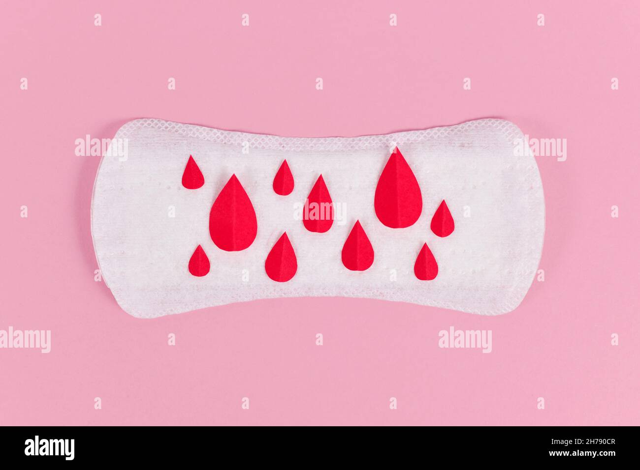 Female period concept with panty liner with symbolic paper blood drops