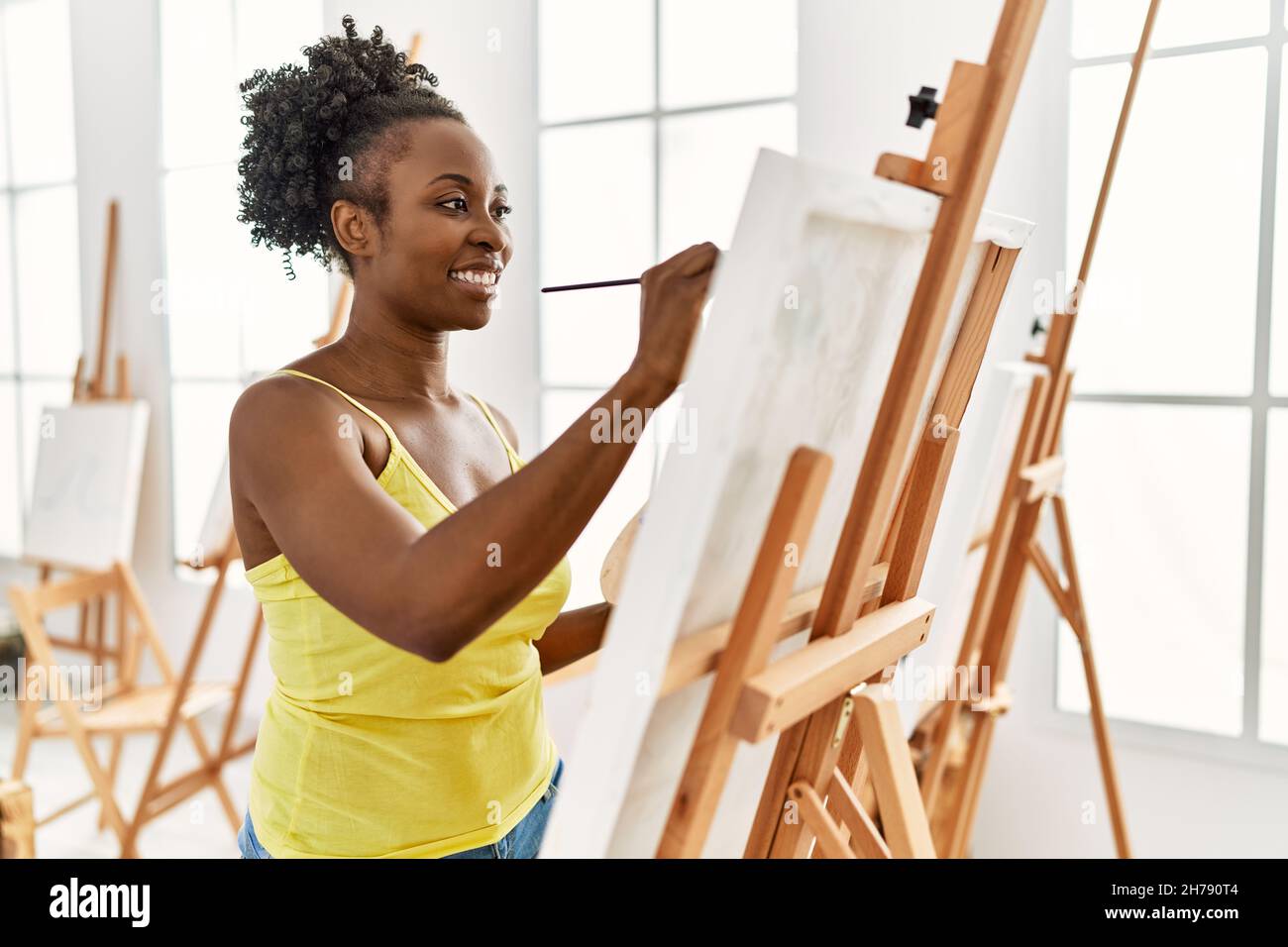 Young african american artist woman smiling happy drawing at art studio ...