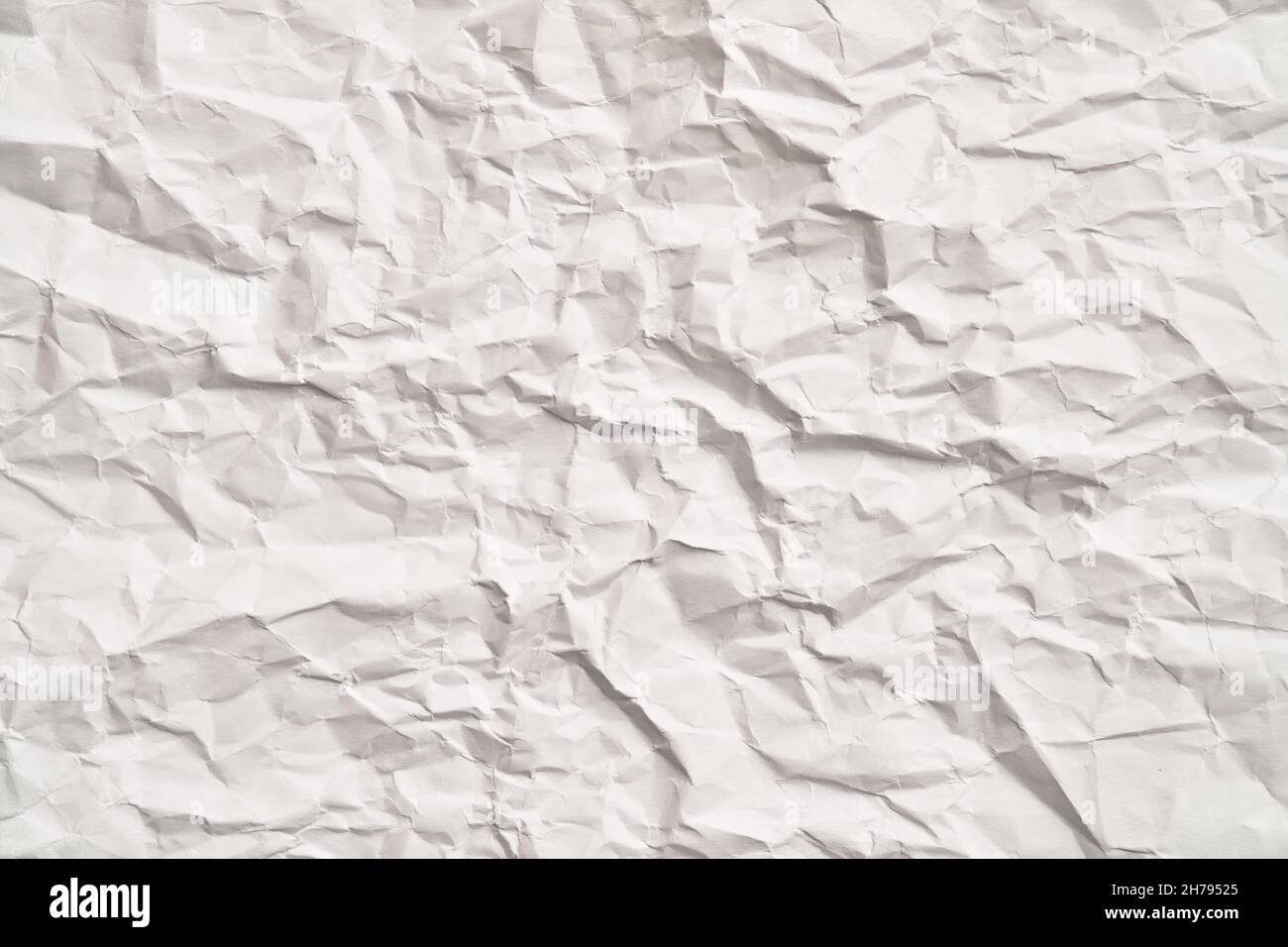 White crumpled paper texture with wrinkles. Damaged and torn sheet