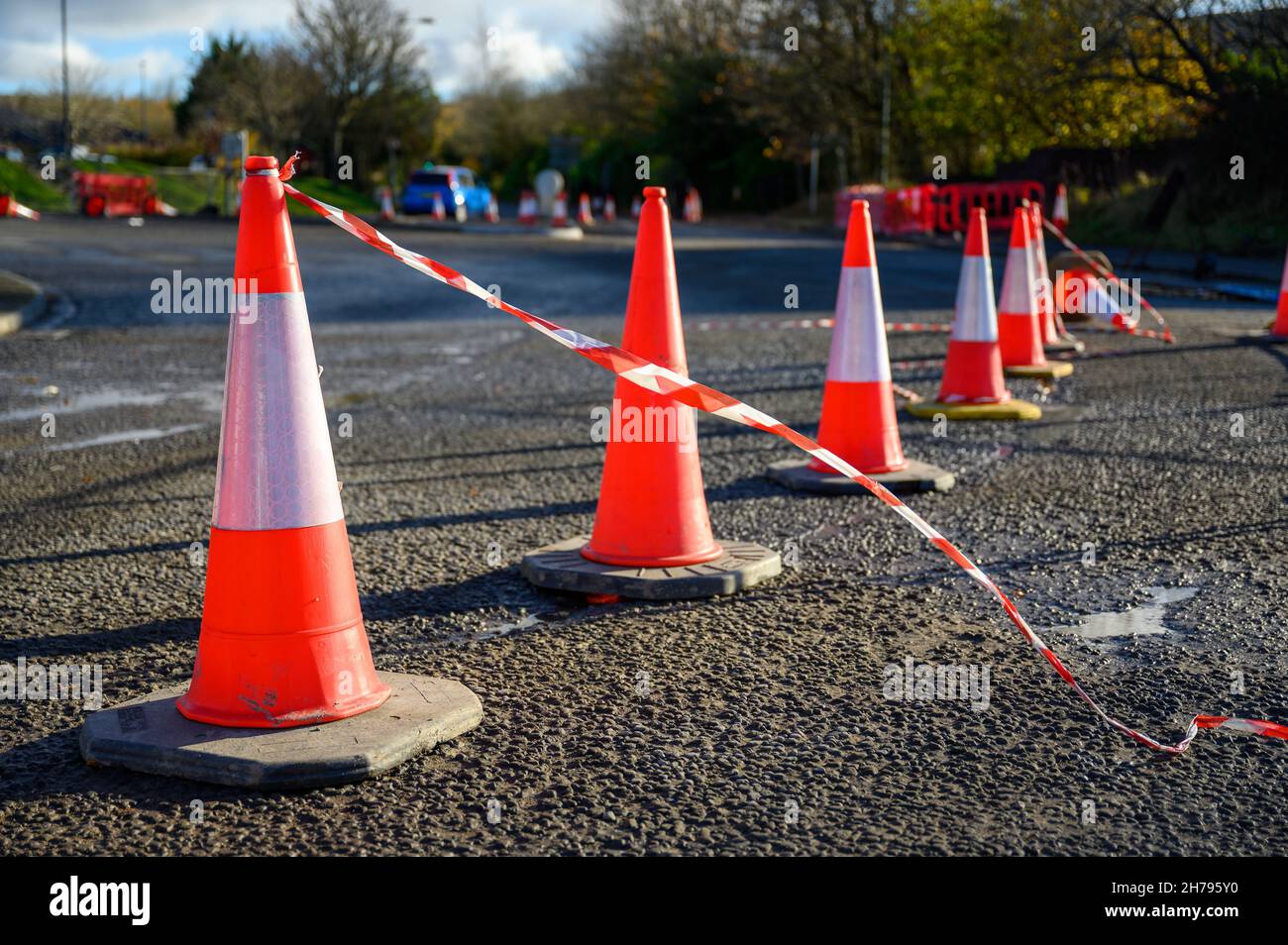 Road works. Orange traffic cones in the middle of the street. Stock Photo