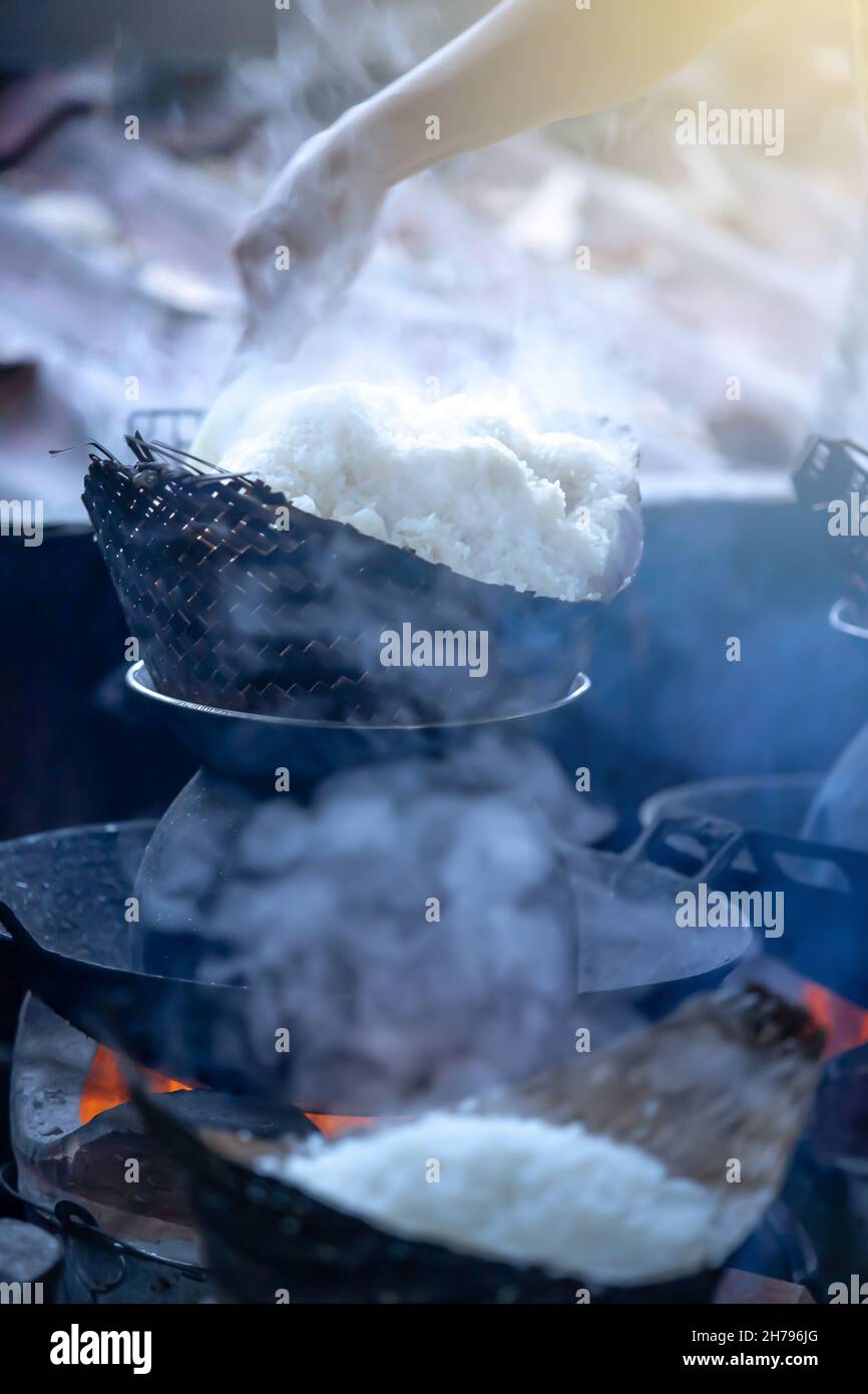 Traditional rice cooker over open fire, sticky rice cooking in a bamboo  basket over simmering water, Living Land Rice Farrm near Luang Prabang,  Laos Stock Photo - Alamy
