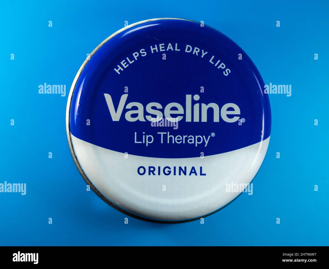 Tin of vaseline lip therapy on a blue background Stock Photo