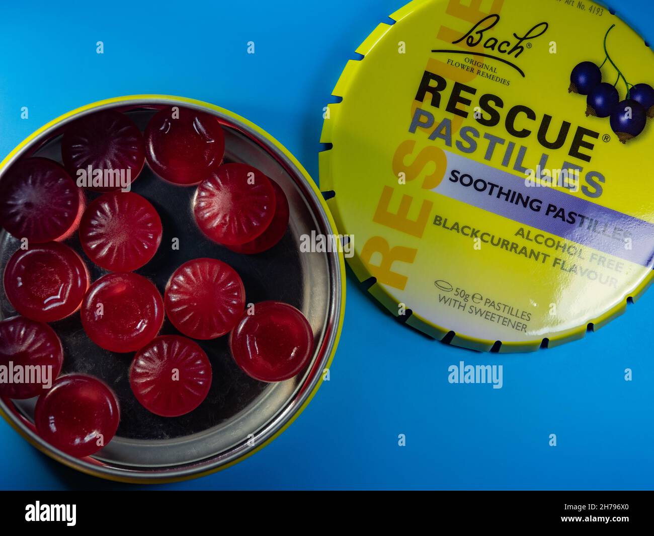 Bach rescue relief pastilles blackcurrant fruit flavoured sweets open tin on a blue background Stock Photo