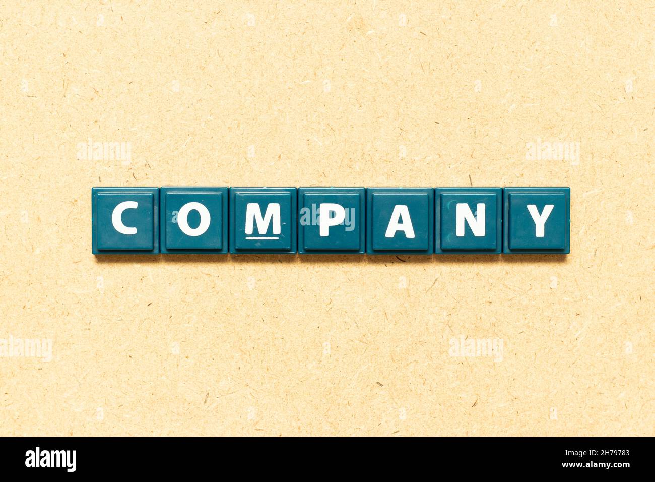 Tile alphabet letter in word company on wood background Stock Photo - Alamy