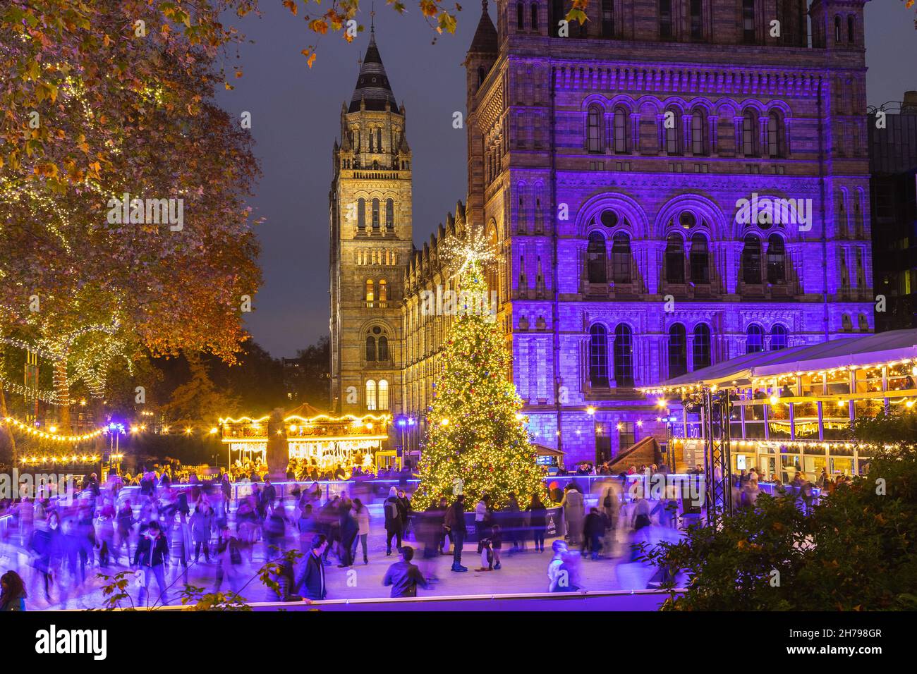 LONDON, UK - 20TH NOV 2021: The outside of the Natural History Museum in London during the Christmas holiday season. Decorations, an ice rink, Christm Stock Photo