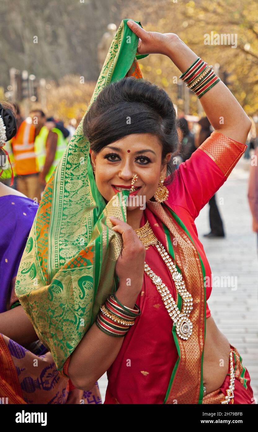 castle street scotland uk 21st november 2021 participants of the edinburgh diwali procession through the city centre stop to pose for photographs before moving on to the evening celebrations at ross bandstand edinburgh diwali is an initiative by the lord provost of edinburgh to bring diwali festival of lights the most famous indian festival to edinburgh so that the mainstream community can share participate and celebrate the victory of good over evil diwali is an indian festival of lights credit arch whitealamy live news 2H79BFB