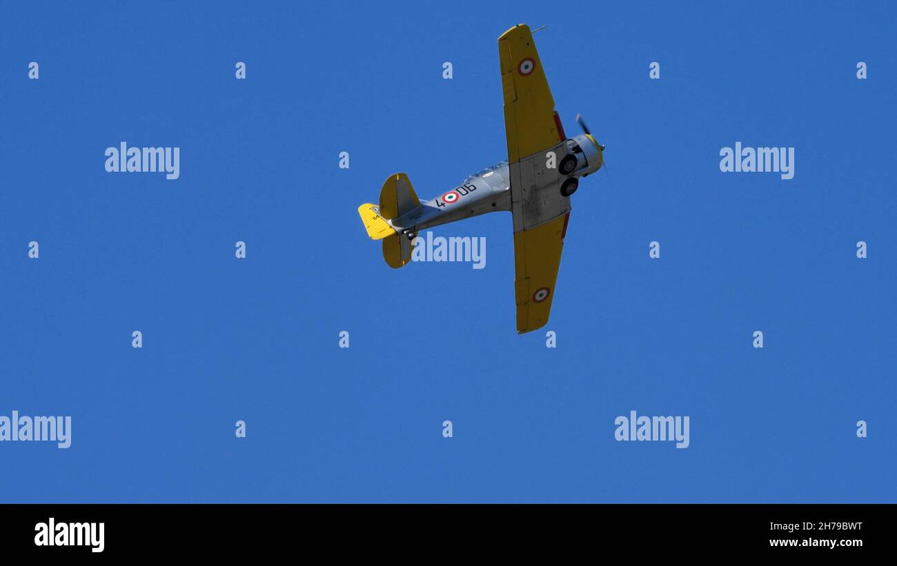 Udine Italy SEPTEMBER, 18, 2021Historic American propeller World War II airplane in the blue sky. North American T-6 Texan or Harvard ex Italian Air Force Stock Photo