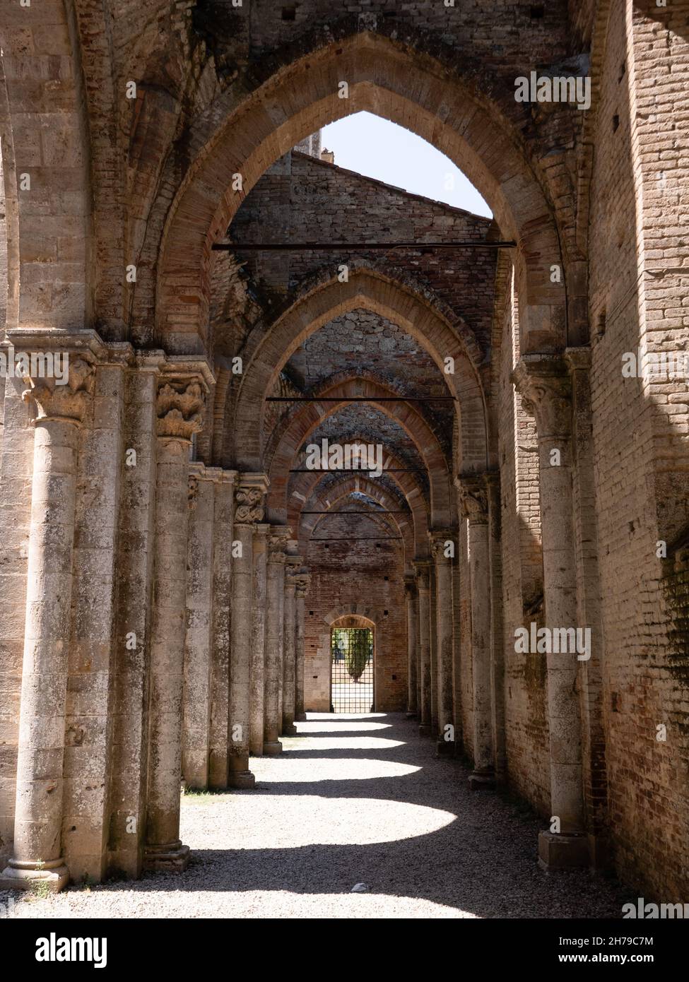 Chiusdino, Italy - August 14 2021: Abbazia San Galgano Abbey, the Ruin of a Gothic Monastery Interior Side Aisle Stock Photo