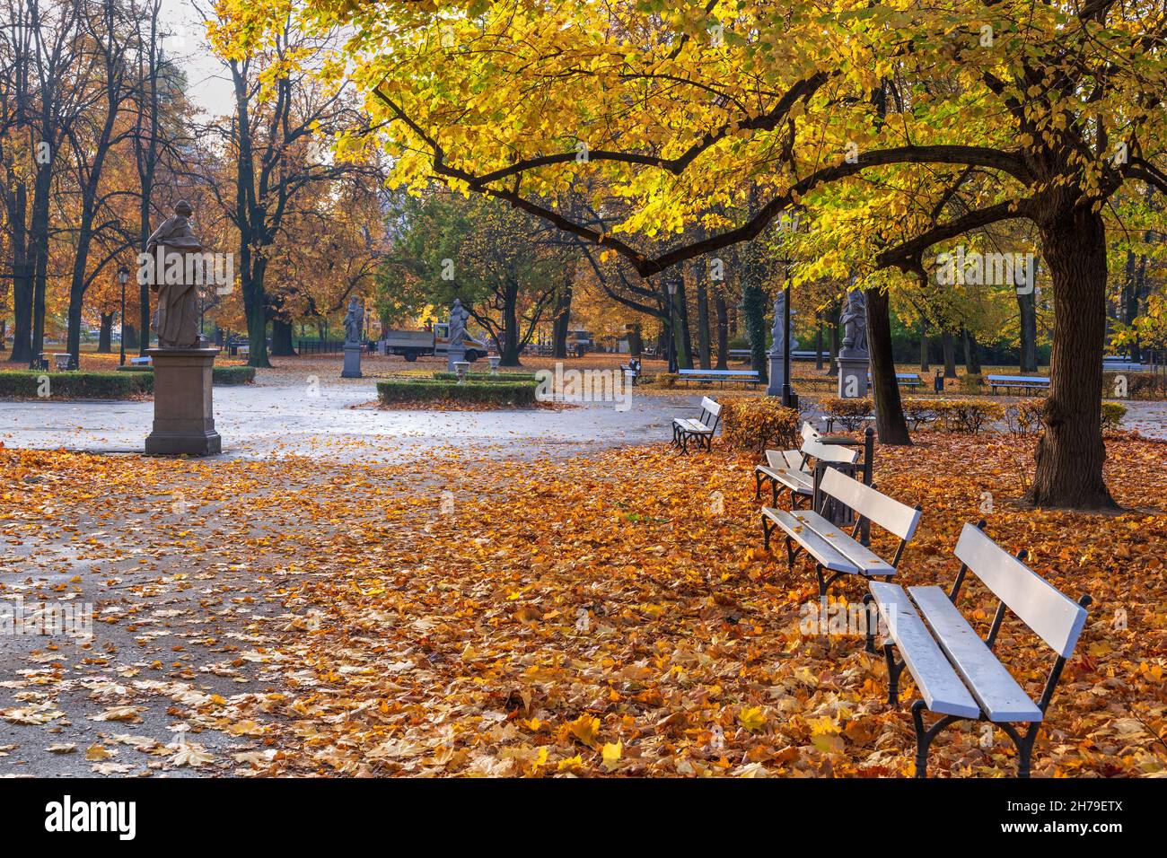 The Saxon Garden (Ogrod Saski) in Warsaw, Poland. Autumn scenery with alleys, fallen leaves and benches, public park in the city center. Stock Photo