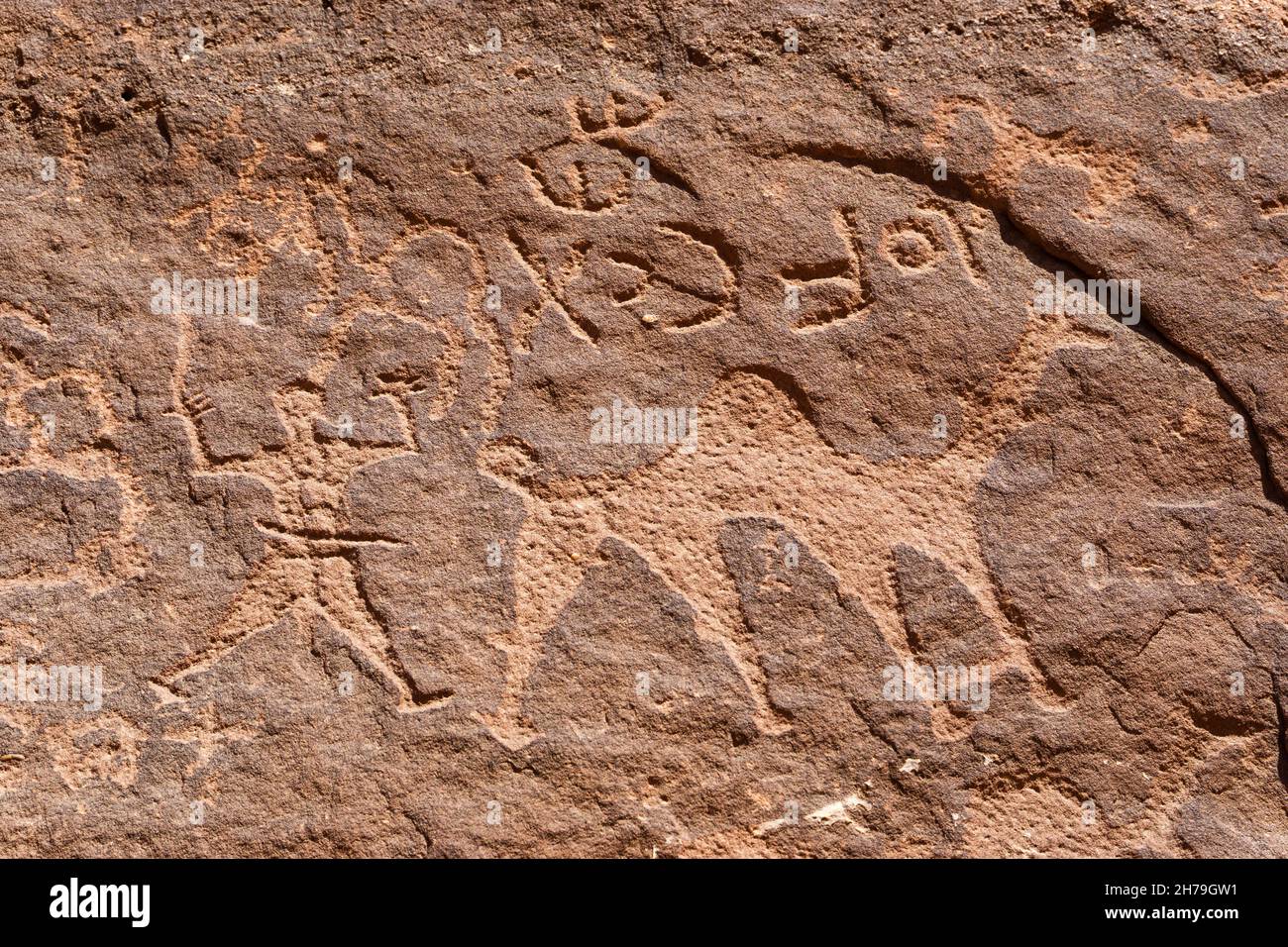 Closeup view of a petroglyph featuring a camel and a man in Wadi Rum, Jordan Stock Photo