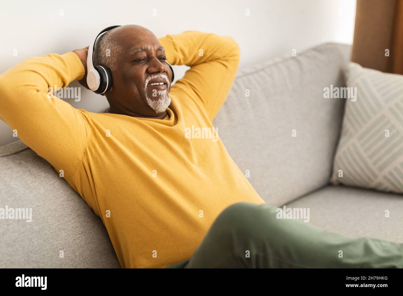 Mature Black Man Listening To Music Wearing Headphones At Home Stock ...