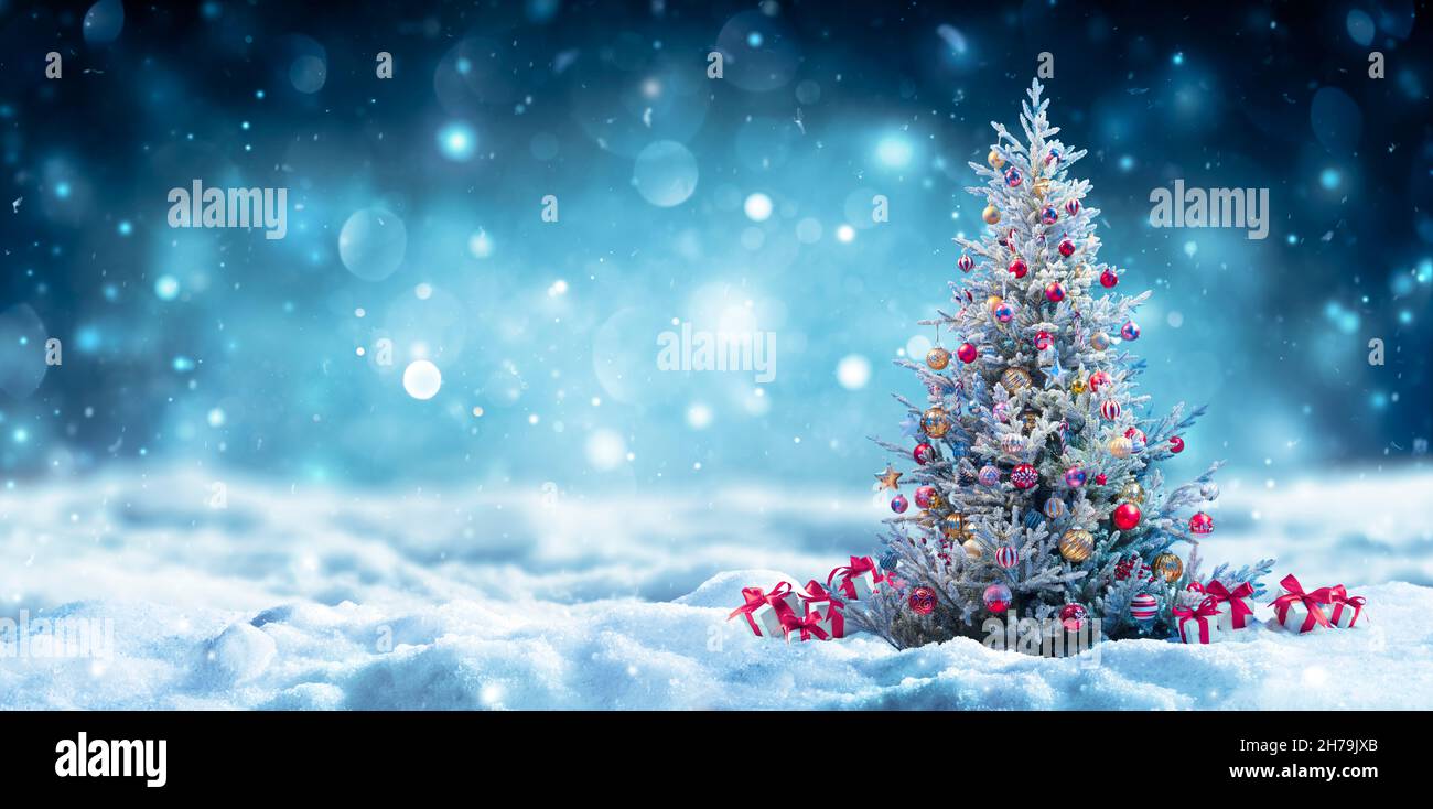 Christmas Tree With Gift On Snow At Night - Snowy Abstract Landscape Stock Photo