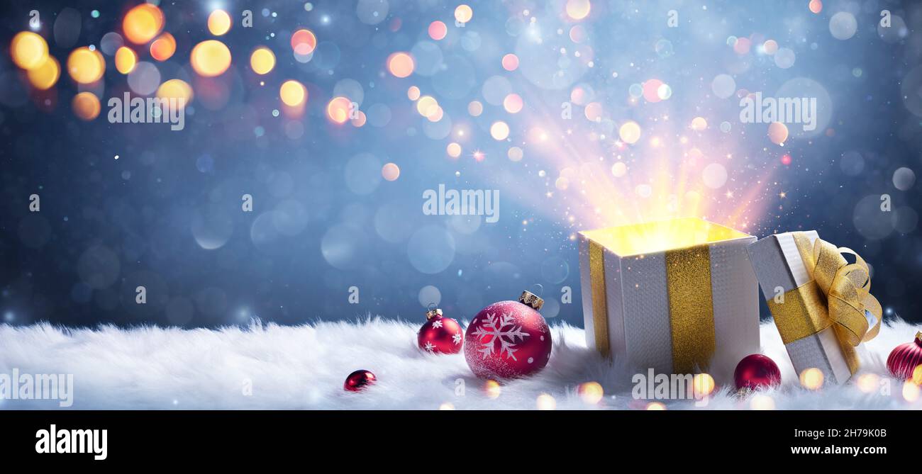 Christmas Present - Open Gift Box With Shiny And Defocused Light And Abstract Bokeh Stock Photo