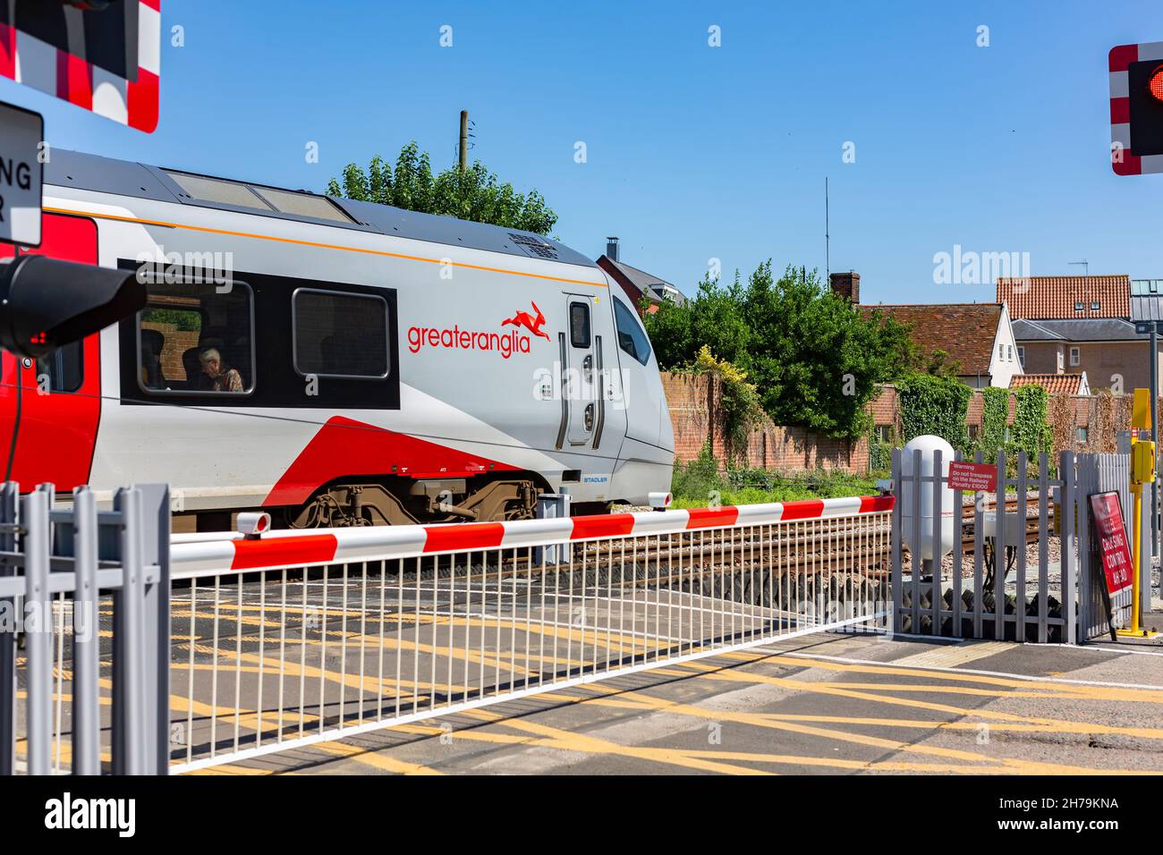 Woodbridge Suffolk UK July 16 2021: A Greater Anglia train passing over a level crossing on its way to Lowestoft from Ipswich Stock Photo