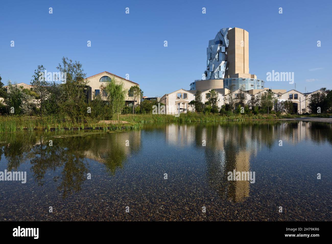 Luma Tower designed by Frank Gehry reflected in the Landscaped Gardens of the Lume Foundation Arts Centre Arles Provence France Stock Photo