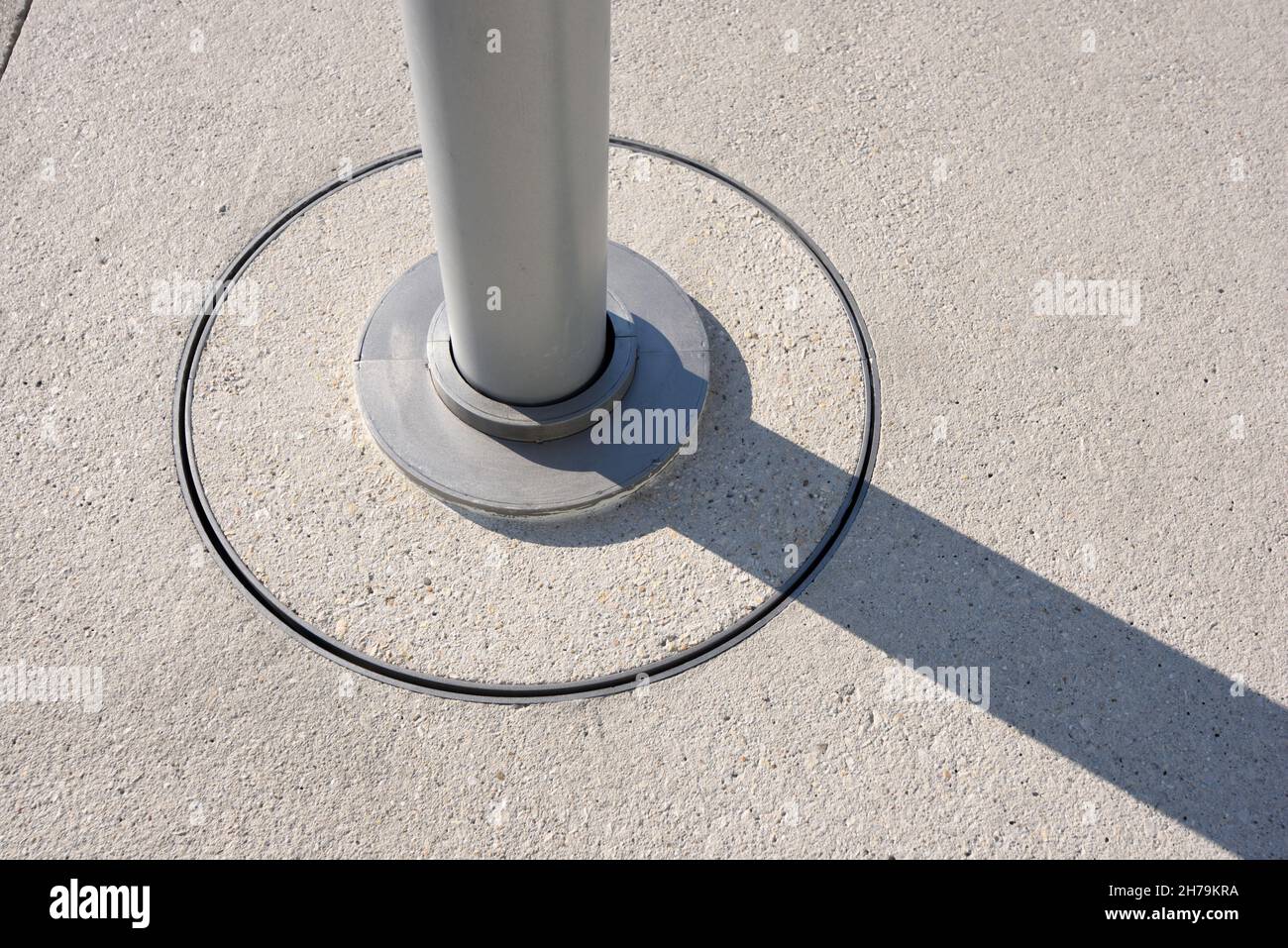 Modernist Lamp Post or Round Metal Pole Detail and Concrete & Steel Pavement Fixture Stock Photo