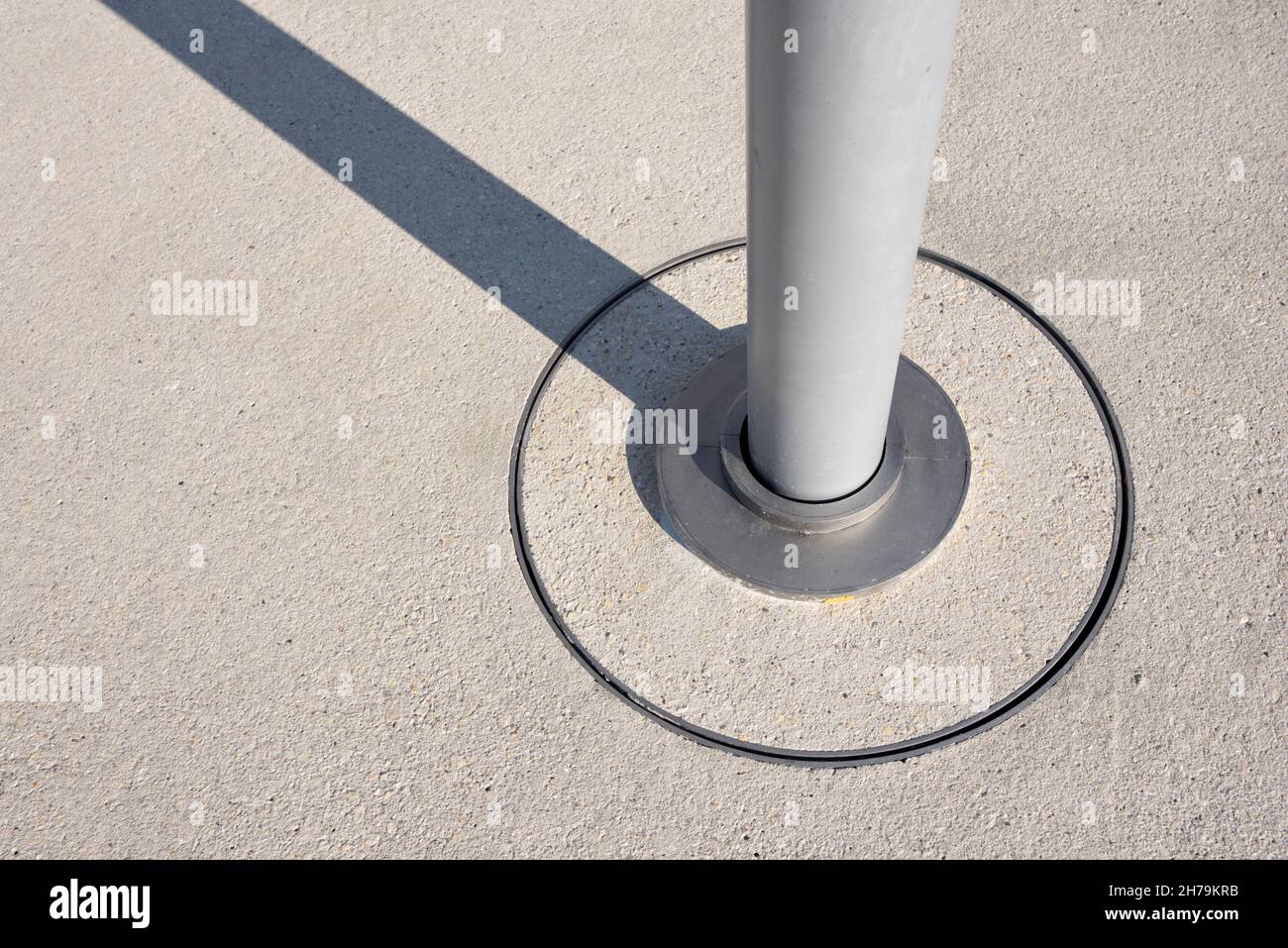 Modernist Lamp Post or Round Metal Pole Detail and Concrete & Steel Pavement Fixture Stock Photo