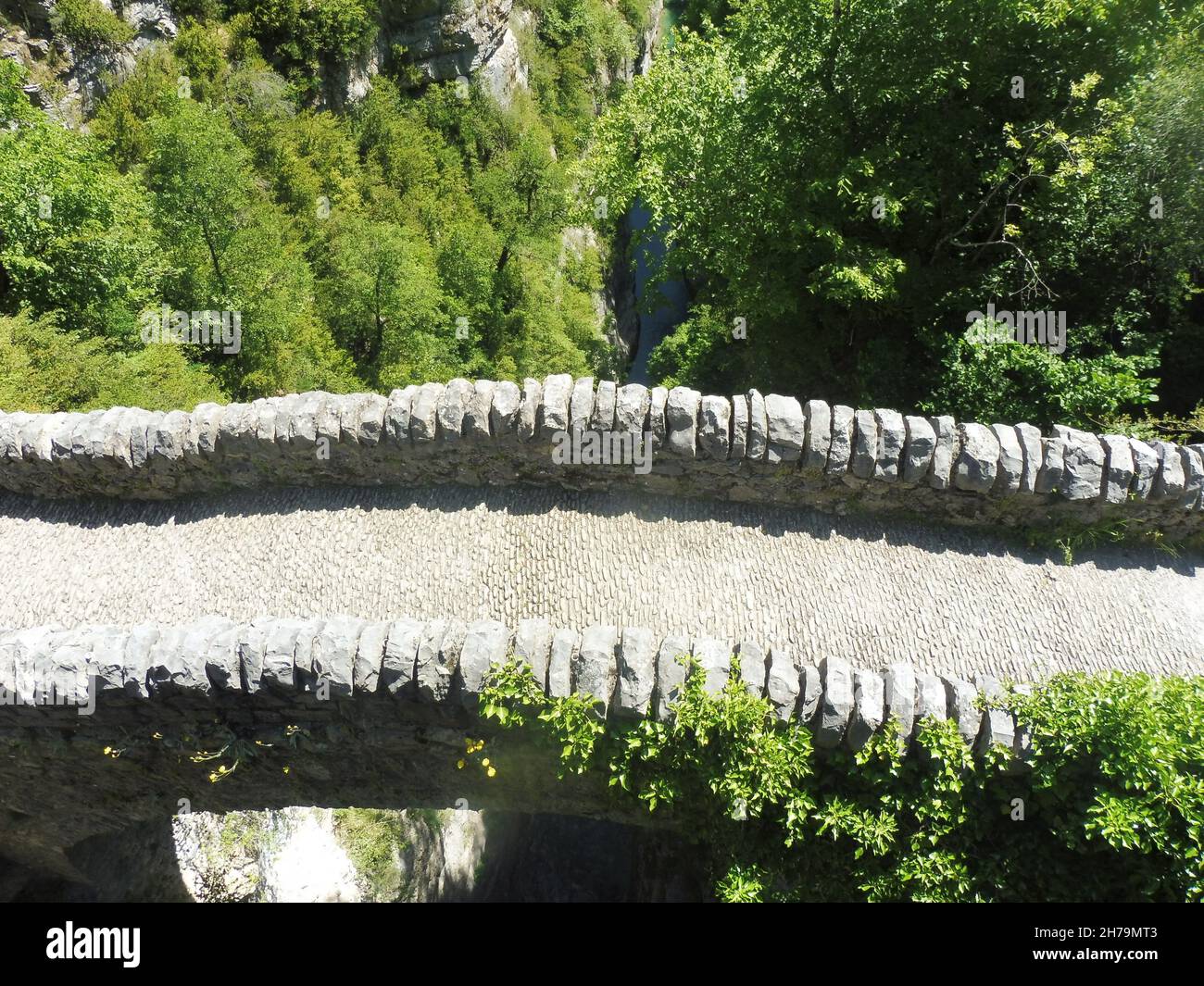 A top view of an empty old stone bridge of San Urbez over the river in nature on a sunny day Stock Photo