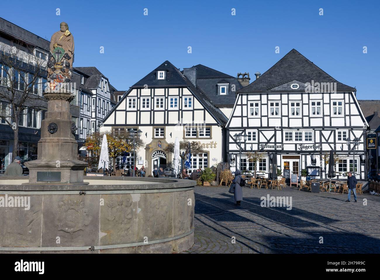 Brilon, Germany - November 12 2021: Marketplace downtown medieval German city Brilon with fountain and facade of medieval restaurant Stock Photo
